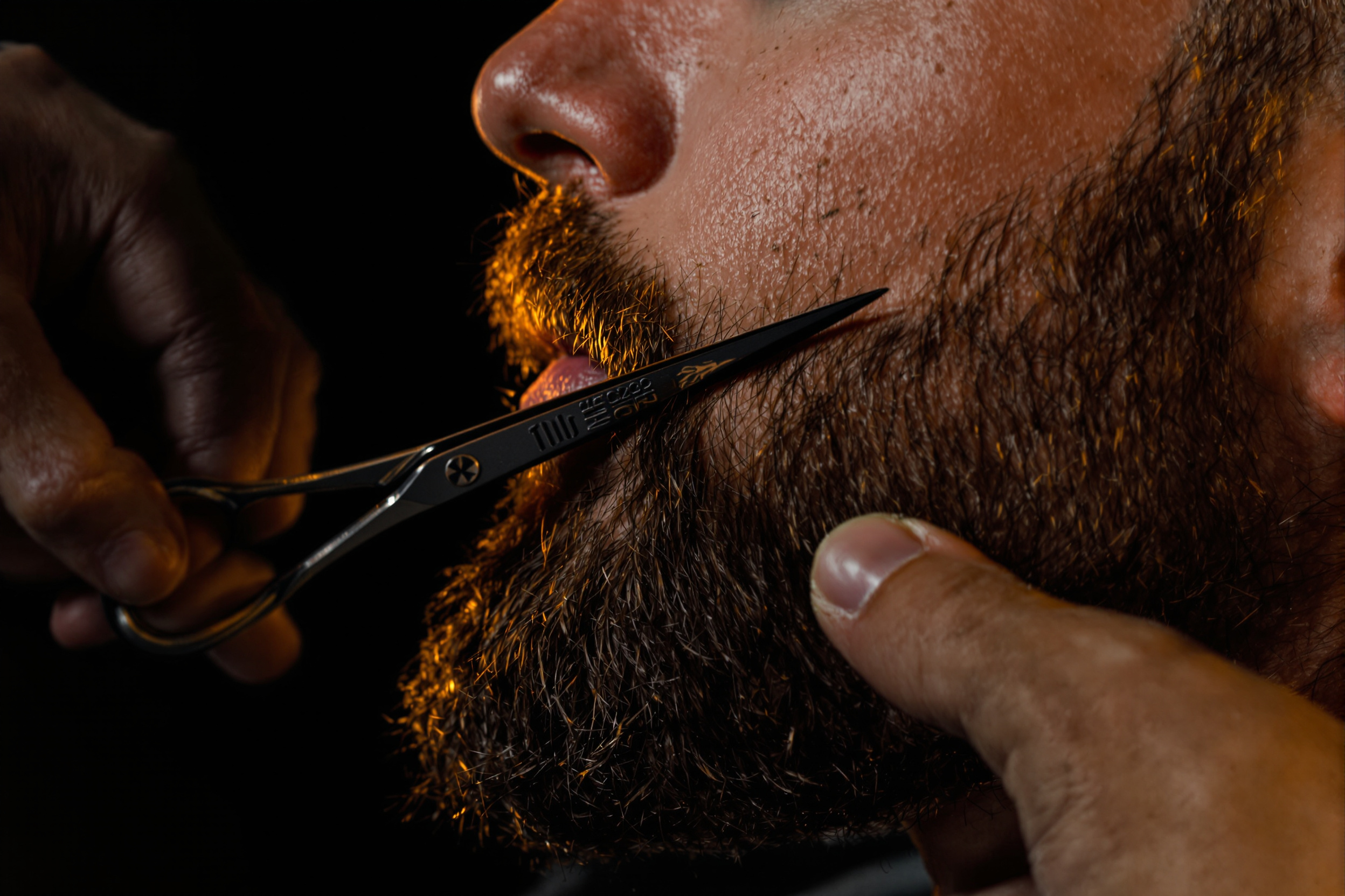 Barber trimming a well-groomed beard at San Ramon Barbershop